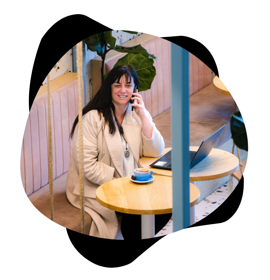 woman on phone whilst working and in cafe
